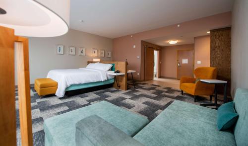 a hotel room with a bed and a couch at Hilton Garden Inn Moncton Downtown, Nb in Moncton