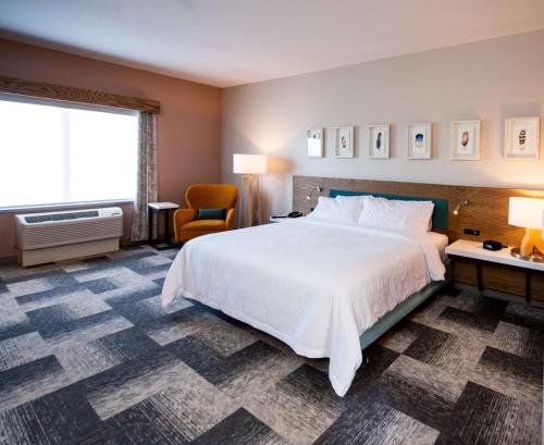 a hotel room with a large bed and a window at Hilton Garden Inn Moncton Downtown, Nb in Moncton