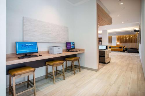 an office with a desk with a computer and stools at Hilton Garden Inn Moncton Downtown, Nb in Moncton