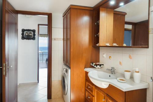 a bathroom with a sink and a washing machine at Anna House in Panteli