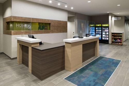 a lobby of a store with two sinks and a counter at Home2 Suites by Hilton Fort Worth Cultural District in Fort Worth