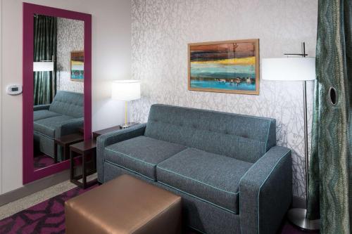 a living room with a couch and a mirror at Home2 Suites by Hilton Fort Worth Cultural District in Fort Worth