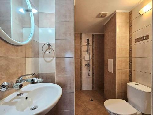 a bathroom with a sink and a toilet and a shower at Villa Magnolia in Sozopol