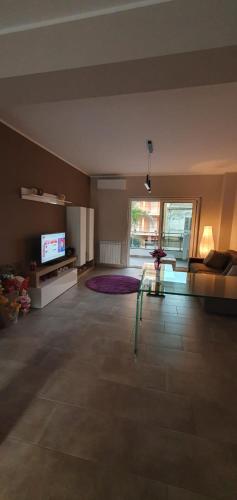 a large living room with a couch and a tv at Casa Glicine in Milazzo