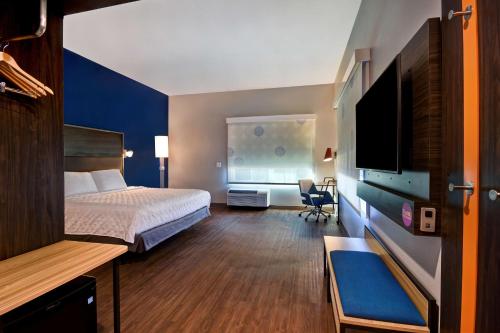 a hotel room with a bed and a flat screen tv at Tru By Hilton Rockwall Dallas, Tx in Rockwall