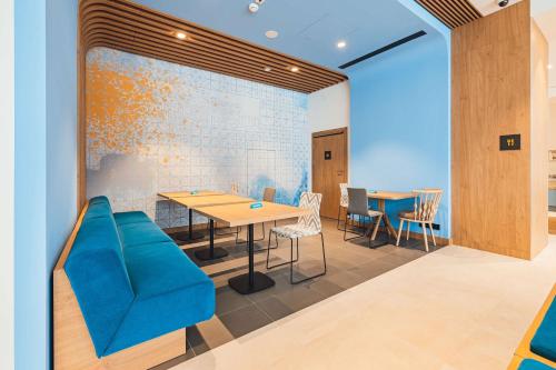 a room with a table and chairs and a wall at Hampton By Hilton Warsaw Reduta in Warsaw