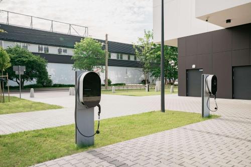 two public pay phones in front of a building at Hampton By Hilton Warsaw Reduta in Warsaw