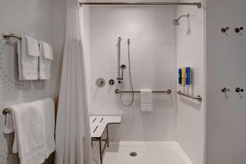 a white bathroom with a shower and a sink at Tru By Hilton Franklin Cool Springs Nashville in Franklin