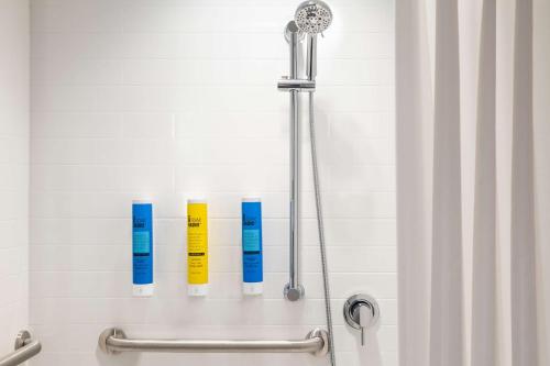 a shower with two blue and yellow thermometers at Tru By Hilton Ogden, Ut in Ogden