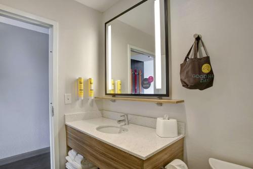 a bathroom with a sink and a mirror at Tru By Hilton Monroe, Oh in Monroe