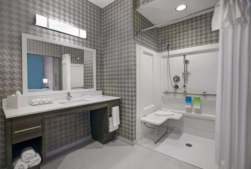 a bathroom with a sink and a toilet and a mirror at Home2 Suites By Hilton Richmond in Richmond