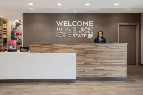 a woman standing at a counter in a store at Hampton Inn Circleville, Oh in Circleville