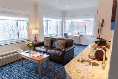 a living room with a couch and a table at Capitol Plaza Hotel Montpelier Tapestry Collection by Hilton in Montpelier