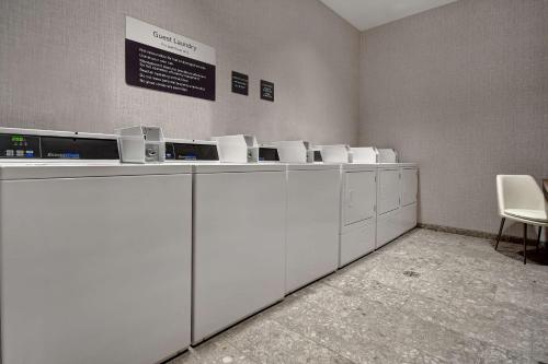 a row of white washing machines in a room at Hilton Garden Inn Kalamazoo Downtown in Kalamazoo