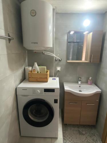 uma pequena casa de banho com uma máquina de lavar roupa e um lavatório em JTverga apartments A3 em Almirón