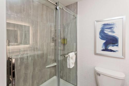 a bathroom with a glass shower with a toilet at Doubletree By Hilton Dothan, Al in Dothan