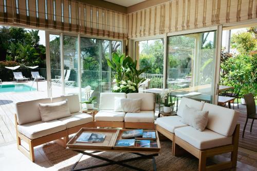 a living room with white couches and a table at Boutique Hôtel Villa Fabulite in Antibes