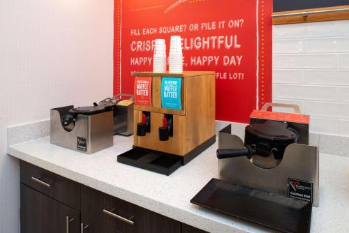 a counter with a coffee maker and a happy day sign at Hampton Inn Kansas City Northeast in Kansas City