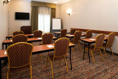 a conference room with wooden tables and chairs at Hampton Inn Kansas City Northeast in Kansas City