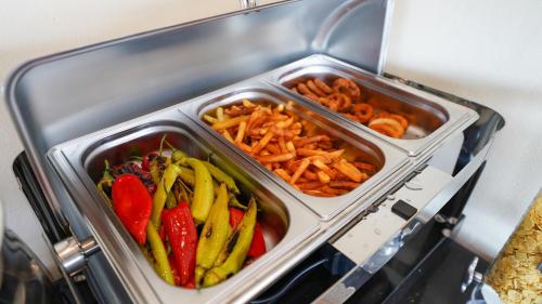 three trays of vegetables and crackers in a refrigerator at Bellezza Hotel in Istanbul