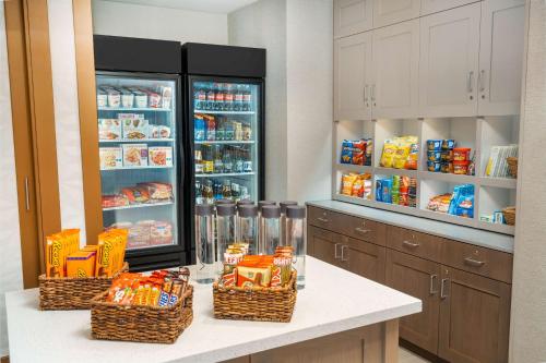 a kitchen with a refrigerator and baskets of food at Homewood Suites By Hilton Livermore, Ca in Livermore