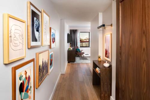 a hallway with a bunch of pictures on the wall at Canopy By Hilton Scottsdale Old Town in Scottsdale