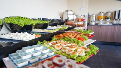 a buffet line of food with shrimp and other foods at Bellezza Hotel in Istanbul