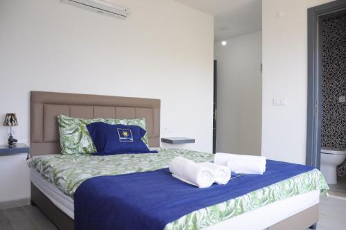 a bedroom with a bed with towels on it at Exclusive Villas in Kusadası