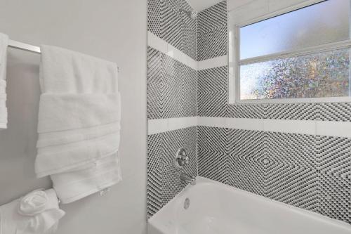 a bathroom with a bath tub and a window at Unique Studio w Parking in Top Location in Atlanta