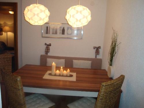 a dining room table with candles on top of it at Apart Austria in Nauders