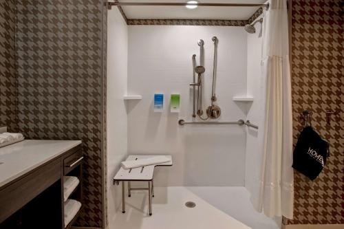 a bathroom with a shower and a toilet and a sink at Home2 Suites By Hilton Lexington Hamburg in Lexington
