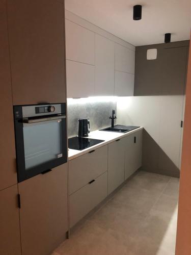 une cuisine avec des armoires blanches et un évier dans l'établissement Lina, à Nice