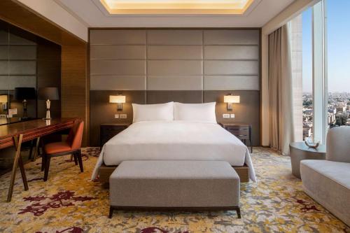 a hotel room with a bed and a desk at DoubleTree Suites by Hilton - Riyadh Financial District in Riyadh