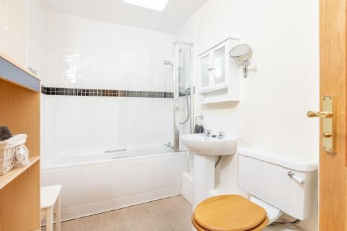 a bathroom with a toilet and a sink and a shower at Barn Cottage 2 bedroom with gorgeous views in Dunblane