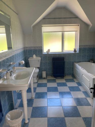 a bathroom with a sink and a tub and a sink and toilet at Millfarm House in Killybegs