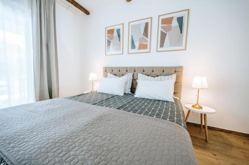 a bedroom with a large bed with two white pillows at Old Town Zagreb Airport in Velika Gorica