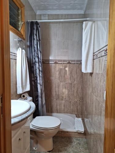 a small bathroom with a toilet and a sink at Casa Islas 1 in Ingenio