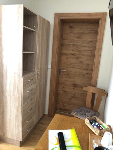 a room with a closet with a wooden door at Gästehaus Baldauf in Berwang