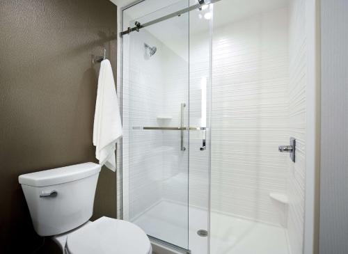 a bathroom with a toilet and a glass shower at Hilton Garden Inn Camden Waterfront Philadelphia in Camden