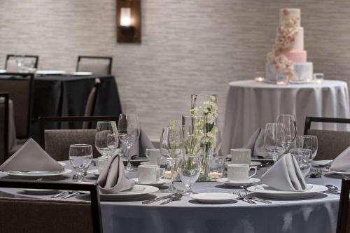 a dining table with a cake on top of it at Hilton Garden Inn Camden Waterfront Philadelphia in Camden