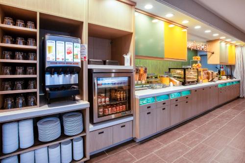 a fast food restaurant with a counter with food at Home2 Suites By Hilton Lewisburg, Wv in Lewisburg