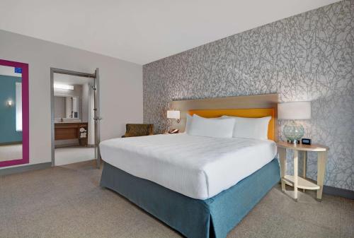 a hotel room with a large bed and a desk at Home2 Suites By Hilton Largo, Fl in Largo