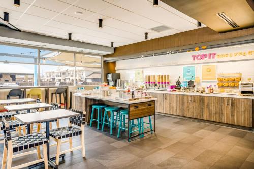 a restaurant with tables and chairs and a counter at Tru By Hilton Midland, Tx in Midland