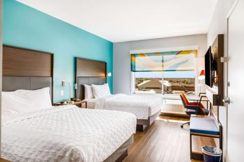 a hotel room with two beds and a window at Tru By Hilton Midland, Tx in Midland
