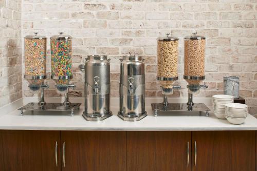 a kitchen counter with two sinks and three food processors at Embassy Suites by Hilton Nashville Downtown in Nashville