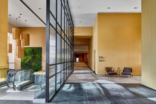 a hallway in a building with chairs and a lobby at Embassy Suites by Hilton Nashville Downtown in Nashville