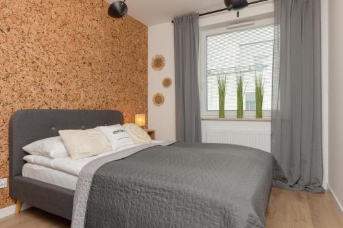 a bedroom with a bed and a window at Trendy Warsaw Apartment with 2 Bedrooms, Balcony & Parking by Renters in Warsaw