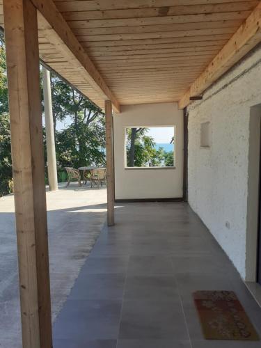 a room with a wooden ceiling and a large window at Residence LE DUNE in Ortona