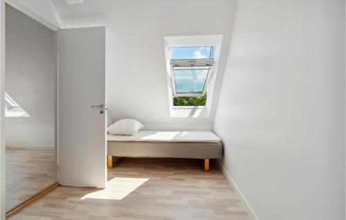 a room with a bed and a window at 2 Bedroom Nice Apartment In Aakirkeby in Åkirkeby
