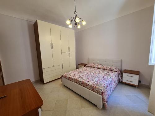 a bedroom with a bed and a dresser and a cabinet at Casa Igea in Siracusa